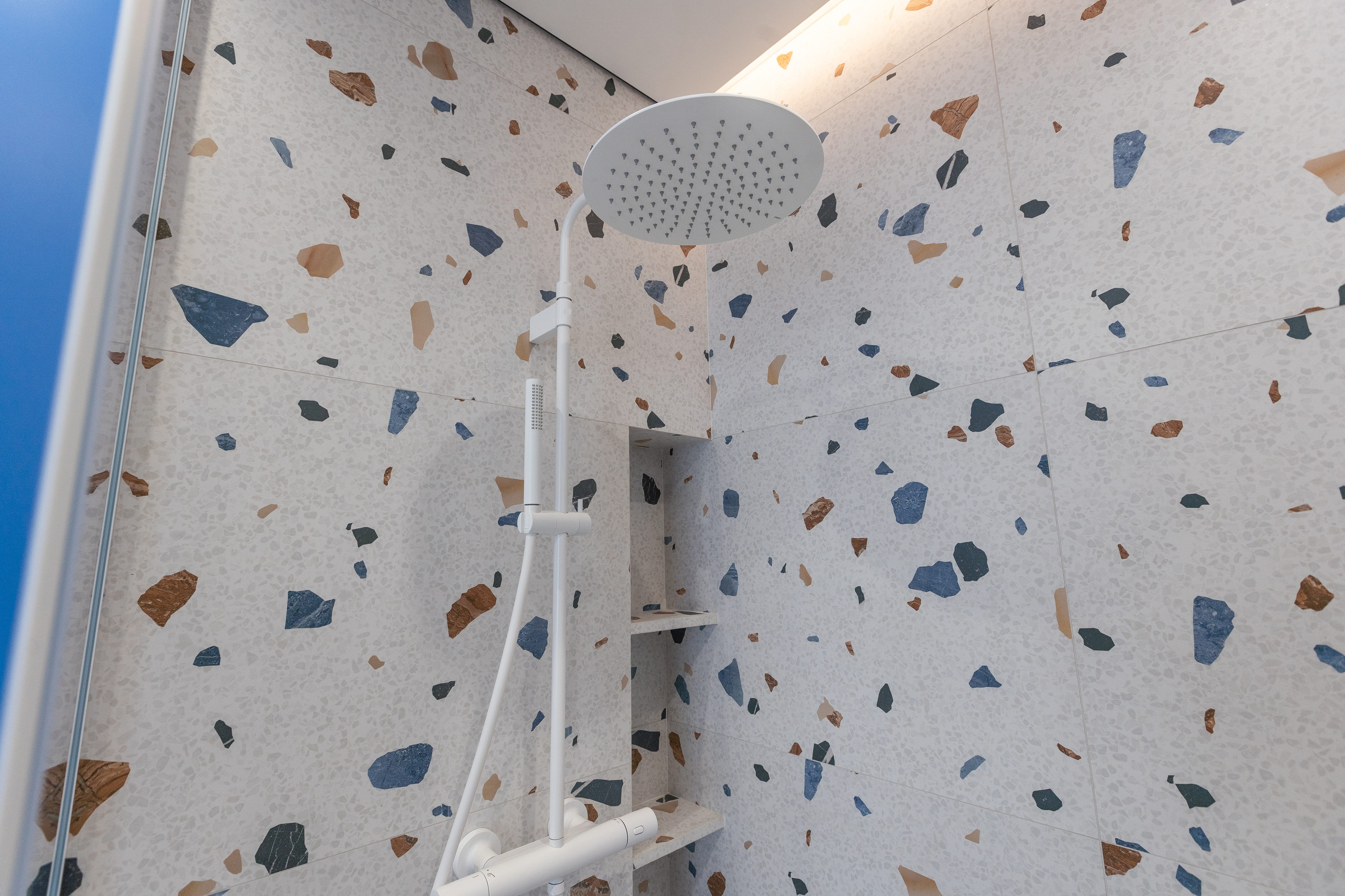 Why Washed Terrazzo is Redefining Modern Interiors in Pakistan 3 bathroom with mosaic tiled shower 2024 07 25 00 20 40 utc